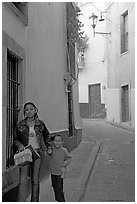 Woman and child walking in a narrow street. Guanajuato, Mexico (black and white)