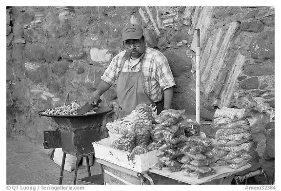 Man selling grilled peanuts on the street. Guanajuato, Mexico (black and white)