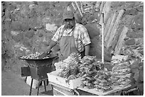 Man selling grilled peanuts on the street. Guanajuato, Mexico ( black and white)