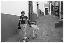 Woman and boy walking down an alleyway. Guanajuato, Mexico ( black and white)