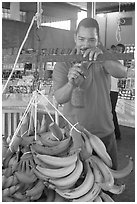Man weighting bananas. Mexico (black and white)