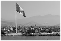 Giean Mexican national flag flying above Malecon, Ensenada. Baja California, Mexico (black and white)