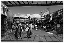 Musicians walking in flee market, La Bufadora. Baja California, Mexico (black and white)