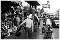 Musicians walking on street, Ensenada. Baja California, Mexico ( black and white)