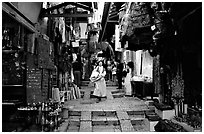 Narrow alley lined with shops. Jerusalem, Israel ( black and white)
