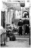 Two christian monks in a narrow alley. Jerusalem, Israel ( black and white)
