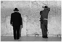 Orthodox Jew and soldier at the Western Wall. Jerusalem, Israel (black and white)