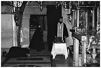 Worshiping inside the Church of the Holy Sepulchre. Jerusalem, Israel (black and white)