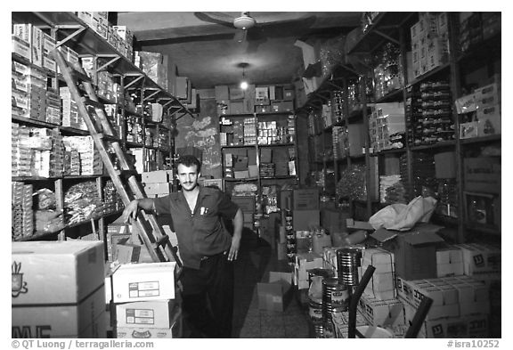 Man in a store, Hebron. West Bank, Occupied Territories (Israel) (black and white)