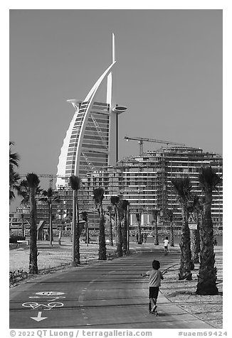 Kids, bike path and Burj Al Arab, Sunset Beach. United Arab Emirates (black and white)