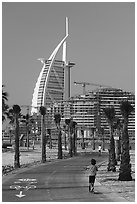 Kids, bike path and Burj Al Arab, Sunset Beach. United Arab Emirates ( black and white)