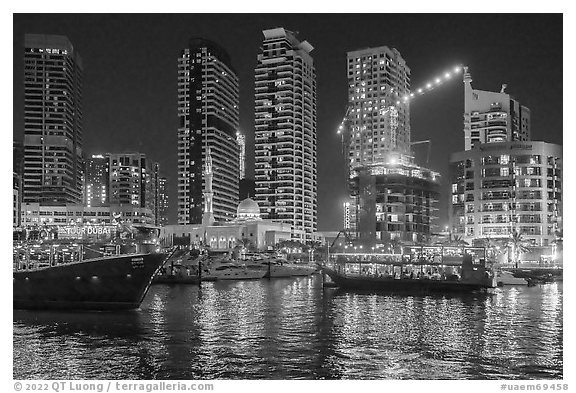 Restaurant boats and Al Rahim Mosque at night. United Arab Emirates (black and white)