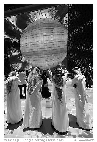 Men in kandura at light show, Saudi Arabia Pavilion. Expo 2020, Dubai, United Arab Emirates (black and white)