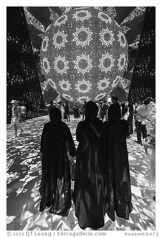 Women in abaya at light show, Saudi Arabia Pavilion. Expo 2020, Dubai, United Arab Emirates (black and white)