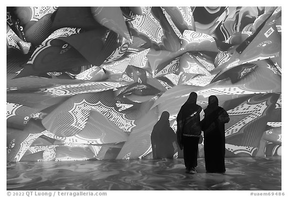 Women interacting with light show, Pakistan Pavilion. Expo 2020, Dubai, United Arab Emirates (black and white)