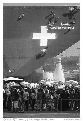 Visitors with umbrellas, Swizerland Pavilion. Expo 2020, Dubai, United Arab Emirates (black and white)