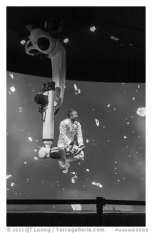 Man performing with robotic arm, Kazakhstan Pavilion. Expo 2020, Dubai, United Arab Emirates (black and white)