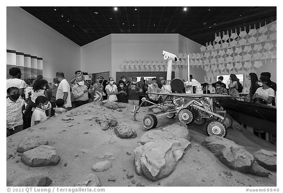 Visitors looking at Mars rover exhibit, USA Pavilion. Expo 2020, Dubai, United Arab Emirates (black and white)