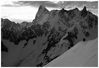 Alpinists go down Aiguille du Midi on a sharp ridge. Alps, France (black and white)