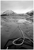 Kayaks prow, floating icebergs, and glacier. Glacier Bay National Park, Alaska (black and white)