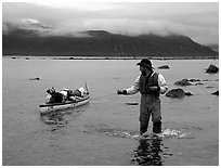 Kayaker tows kayak near Scidmore Bay. Glacier Bay National Park, Alaska (black and white)