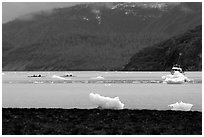 Taxi boat, kayaks, and icebergs near McBride Glacier. Glacier Bay National Park, Alaska (black and white)