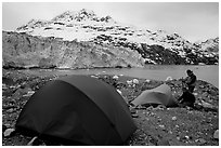 Campers set-up a tent in front of Lamplugh Glacier. Glacier Bay National Park, Alaska (black and white)