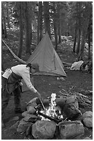 Woman preparing food at campfire, Le Conte Canyon. Kings Canyon National Park, California (black and white)
