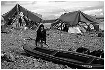Inflating the canoe next to an Eskimo fish camp in Ambler. Kobuk Valley National Park, Alaska (black and white)