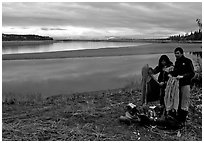Canoeist drying out clothing over a campfire. Kobuk Valley National Park, Alaska (black and white)