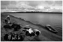 Canoeist packing the camping gear. Kobuk Valley National Park, Alaska (black and white)