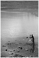 Large format photographer with tripod on the shores of Turquoise Lake. Lake Clark National Park, Alaska (black and white)