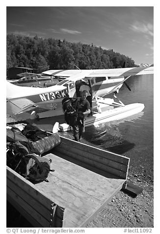 Backpackes being unloaded from floatplane in Port Alsworth. Lake Clark National Park, Alaska