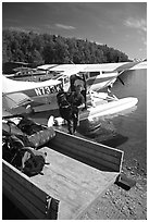Backpackes being unloaded from floatplane in Port Alsworth. Lake Clark National Park, Alaska (black and white)