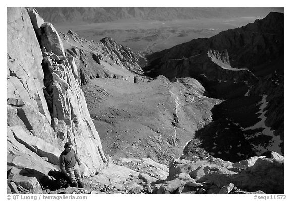 Man pausing on steep terrain in the East face of Mt Whitney. Sequoia National Park, California