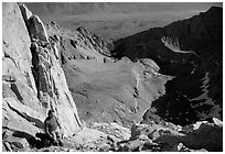 Man pausing on steep terrain in the East face of Mt Whitney. Sequoia National Park, California (black and white)