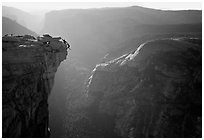 Hanging dramatically from the Jumping Board, Half-Dome. Yosemite National Park, California (black and white)