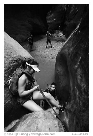 Canyoneer lowers herself using rope, Orderville Canyon. Zion National Park (black and white)
