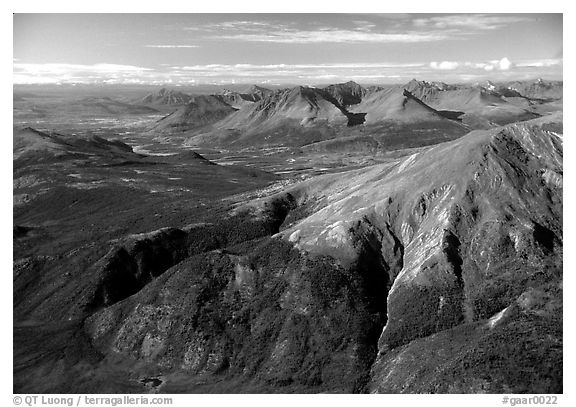 Aerial view of mountains with meandering Alatna river in the distance. Gates of the Arctic National Park, Alaska, USA.