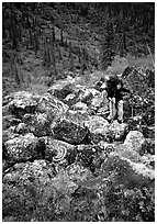 Backpacker on boulder field in Arrigetch Creek. Gates of the Arctic National Park, Alaska (black and white)