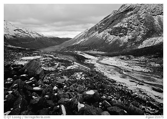 Boulders, valleys and slopes with fresh snow in cloudy weather. Gates of the Arctic National Park (black and white)