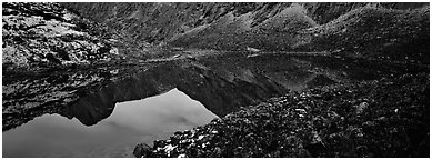 Mountain lake with reflections in rocky environment. Gates of the Arctic National Park (Panoramic black and white)