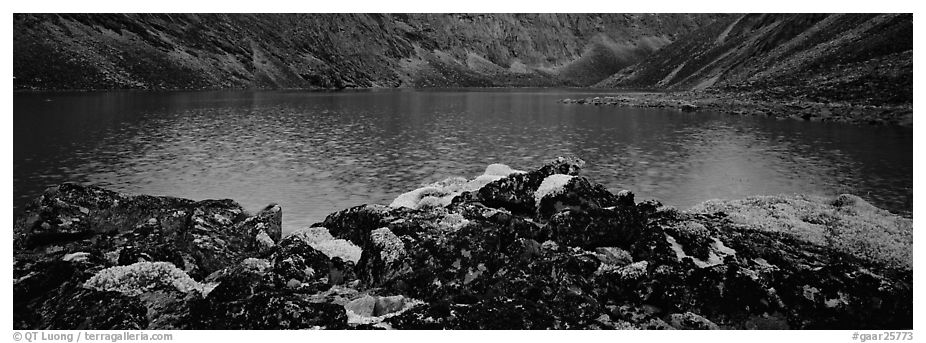 Dark rocks, lichen, and mountain lake. Gates of the Arctic National Park (black and white)