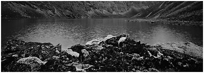 Dark rocks, lichen, and mountain lake. Gates of the Arctic National Park (Panoramic black and white)