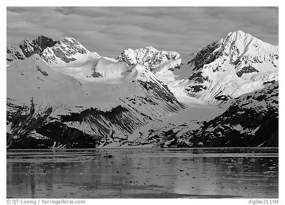 Coastal mountains with glacier dropping into icy fjord. Glacier Bay National Park (black and white)