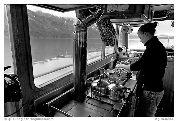 Chef preparing sadad in the main cabin of the Kahsteen. Glacier Bay National Park (black and white)