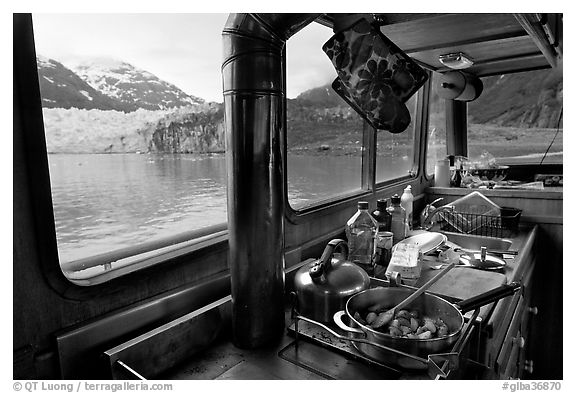 Breakfast potatoes in a small boat moored in front of glacier. Glacier Bay National Park, Alaska, USA.