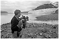Cameraman filming in Tarr Inlet. Glacier Bay National Park, Alaska, USA. (black and white)