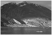 Sunset light falling on the base of the peaks around Tarr Inlet. Glacier Bay National Park ( black and white)