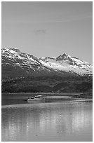 Small boat at the head of Tarr Inlet, early morning. Glacier Bay National Park, Alaska, USA. (black and white)